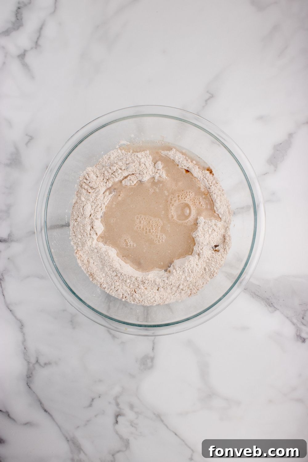 flour and yeast mixture in a glass bowl for the cinnamon raisin bread 