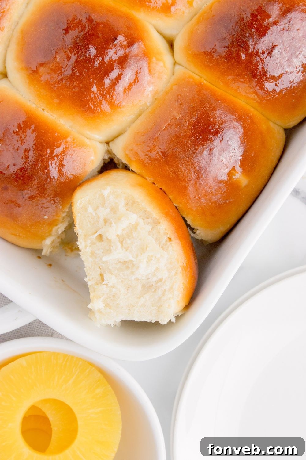 Tropical Dinner Buns 15 Hawaiian Dinner Rolls in a pan with one tilted on the side to show fluffy texture