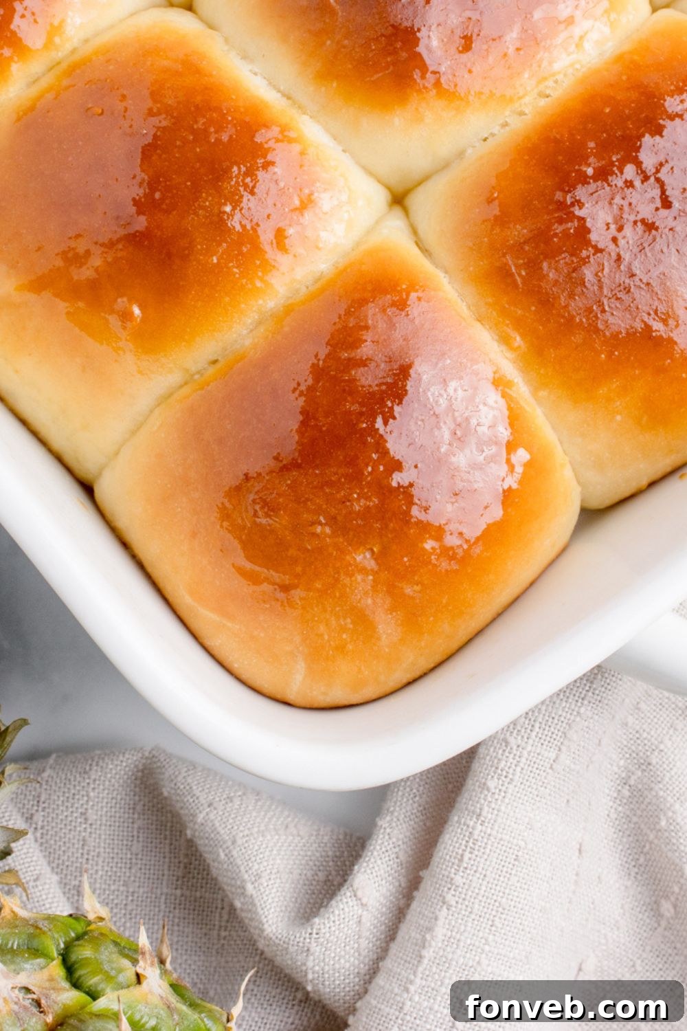 Tropical Dinner Buns 23 hawaiian sweet rolls in a pan that are buttered