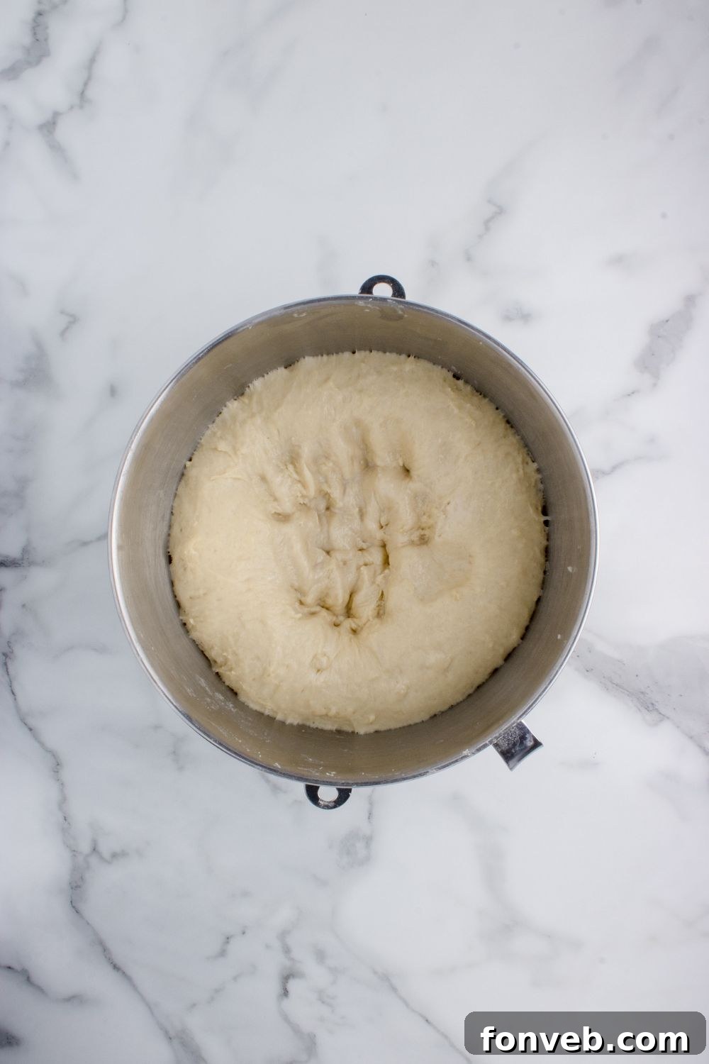Tropical Dinner Buns 10 bread dough risen in a bowl on table for making Hawaiian rolls