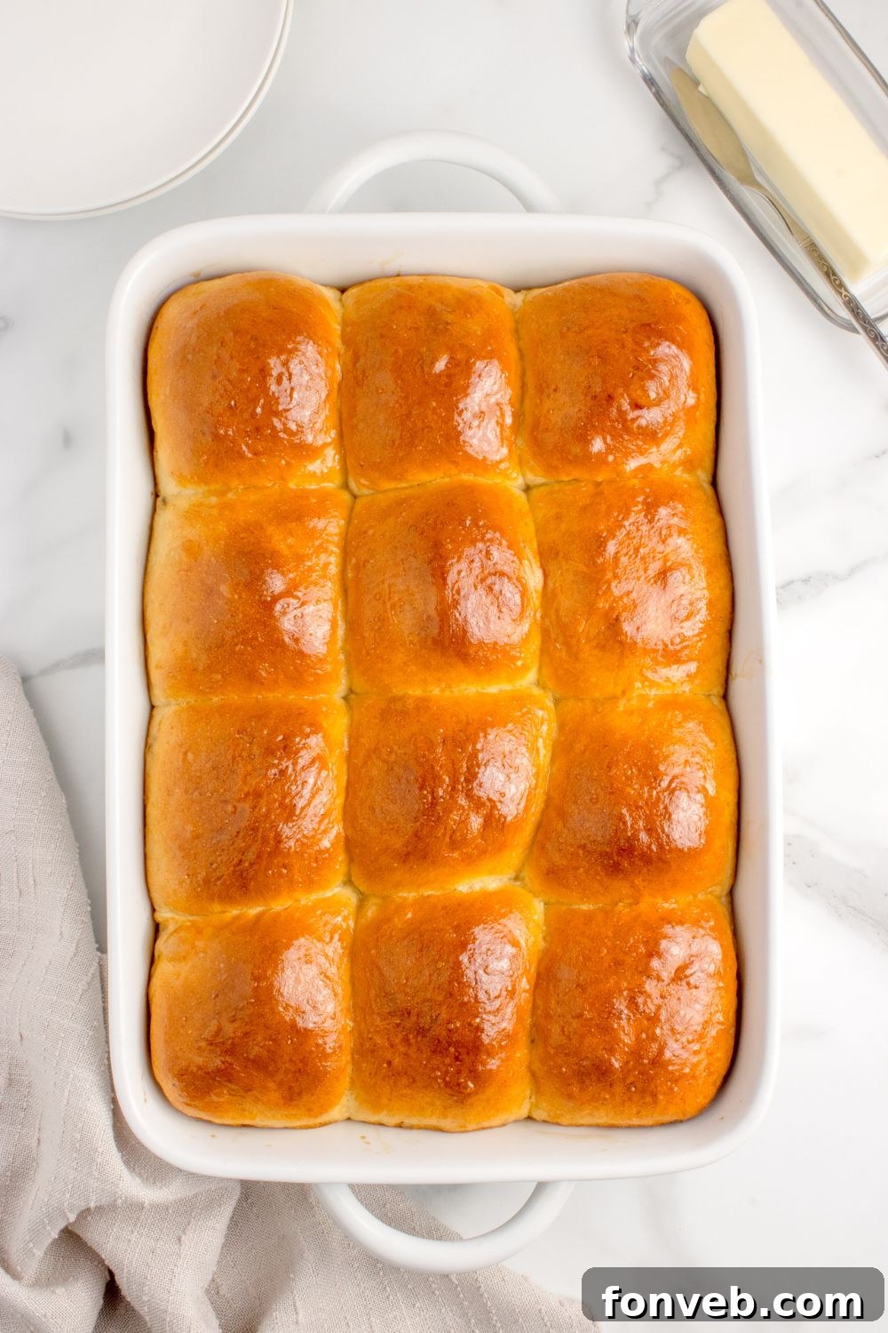 buttery baked pull apart rolls in casserole pan on table