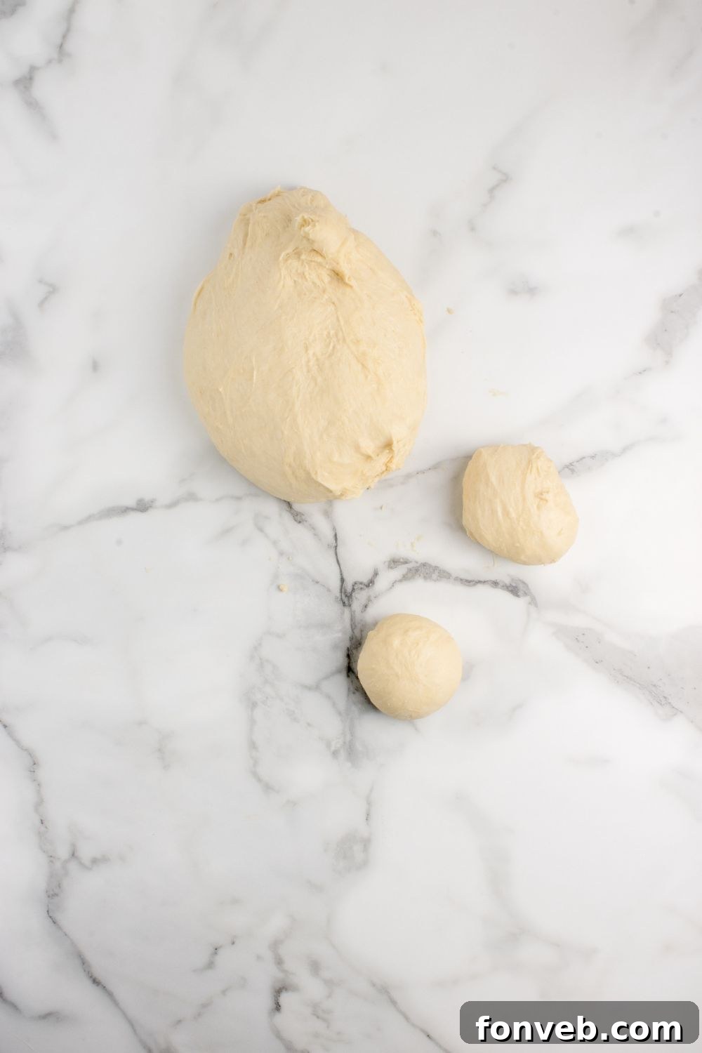 pull apart roll dough on counter rolled into balls