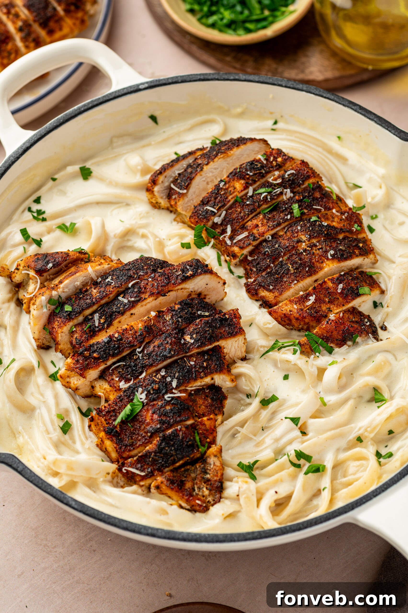 Cajun Chicken Alfredo 2 blackened chicken alfredo in a baking dish with parsley and grated parmesan cheese on top