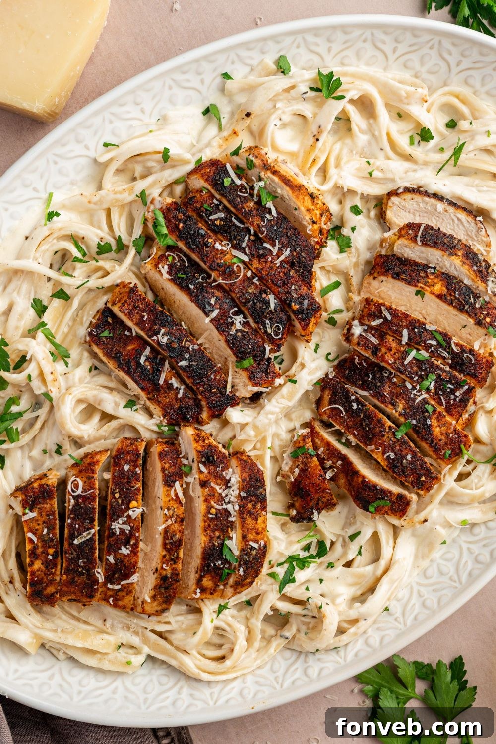 Cajun Chicken Alfredo 15 Blackened Chicken Alfredo in a large casserole dish with garnish on top of it