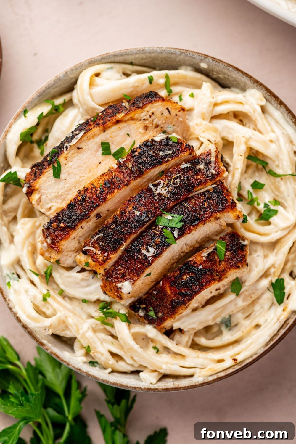 Cajun Chicken Alfredo 18 Blackened Chicken Alfredo in a bowl with parsley and parmesan grated on top of bowl