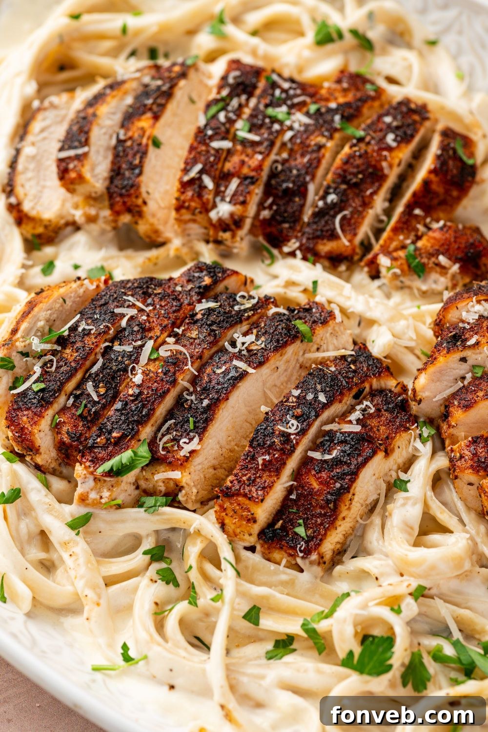 Cajun Chicken Alfredo 19 Blackened Chicken Alfredo in a platter with sliced chicken on top