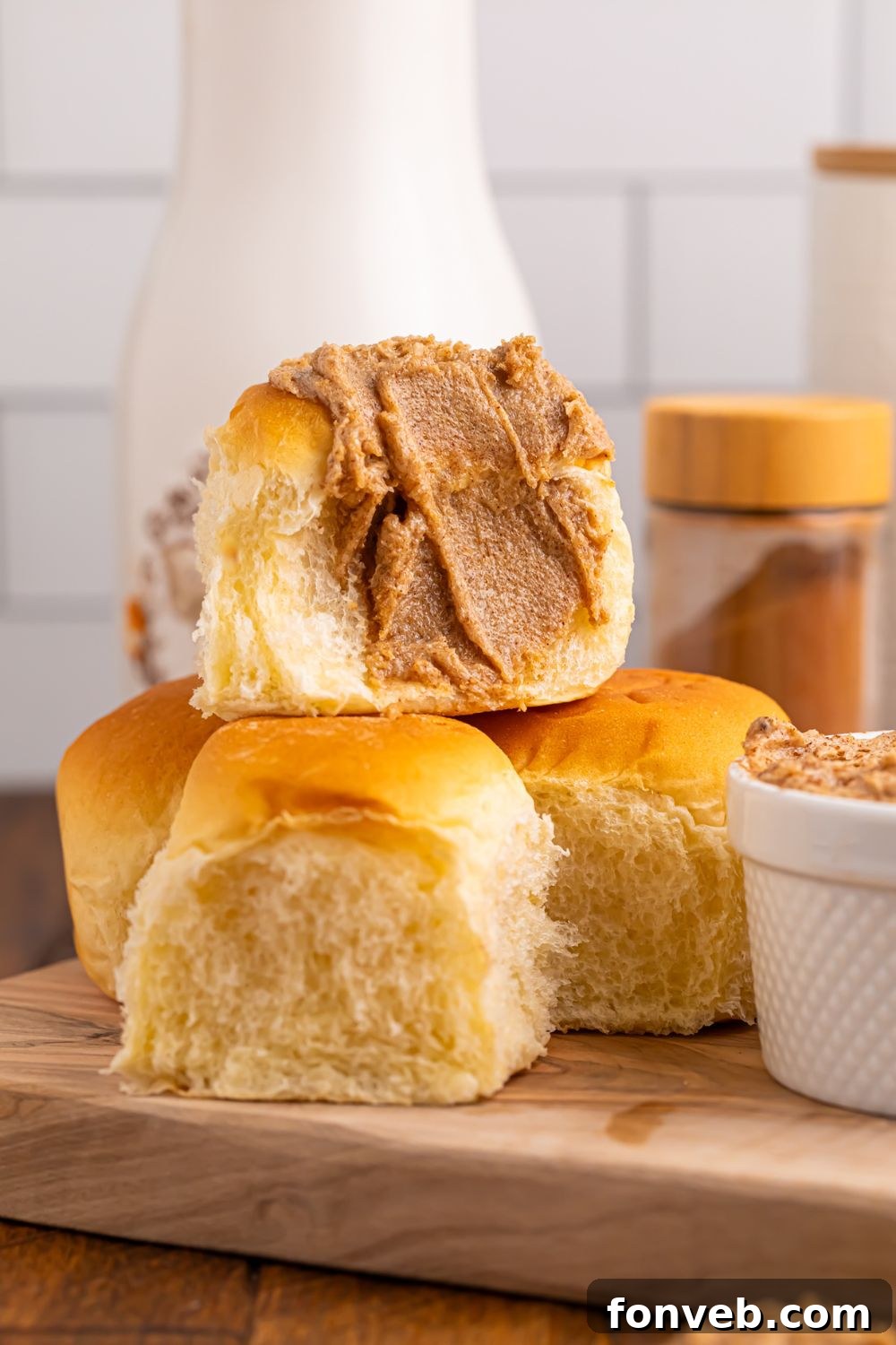 Brown Sugar Cinnamon Butter spread on rolls sitting on a cutting board on table 