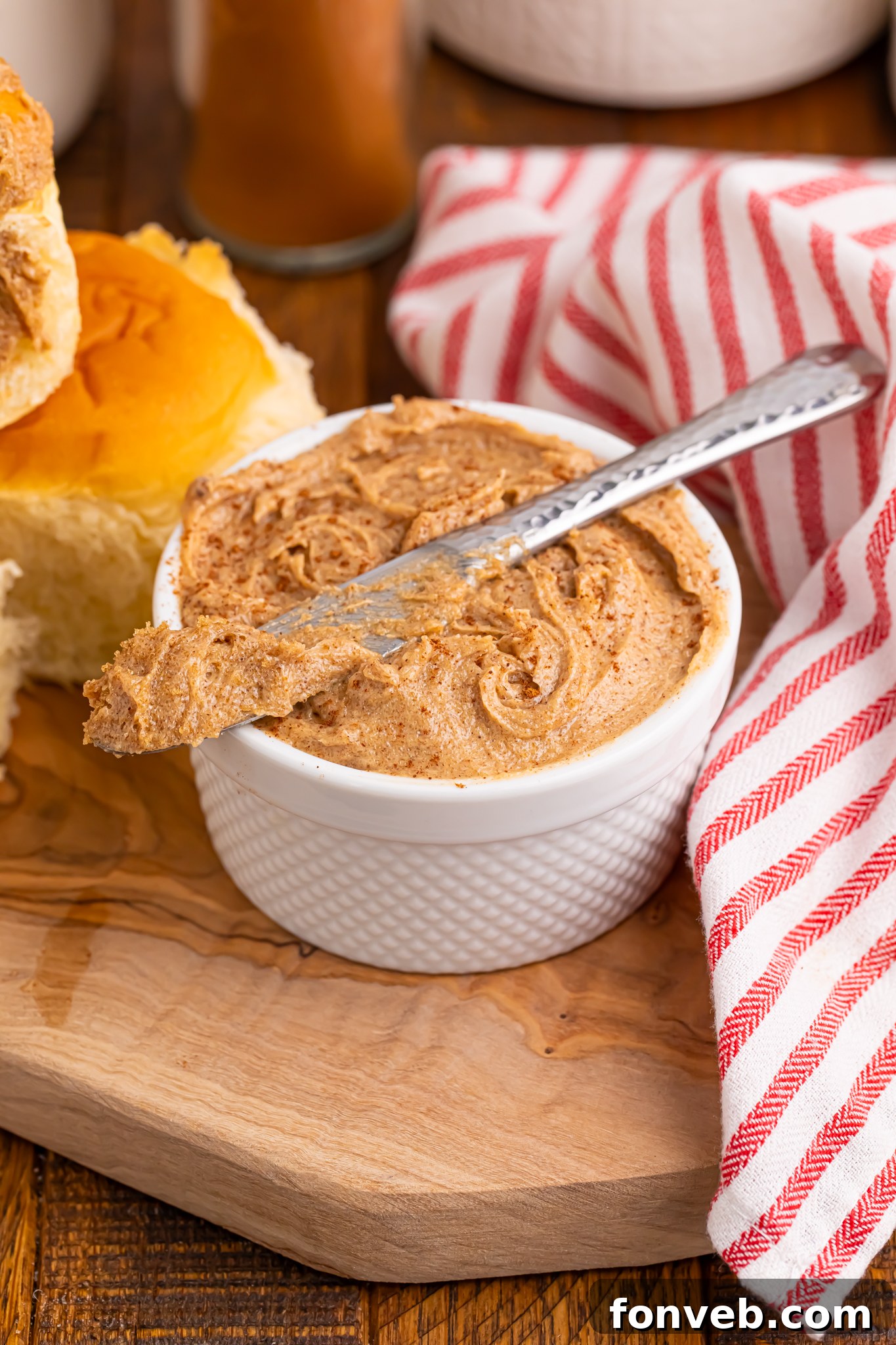 Brown Sugar Cinnamon Butter in a small container on table with a knife on top of bowl