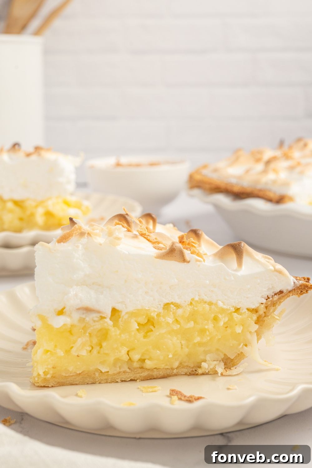 Coconut Meringue Pie sliced on plates