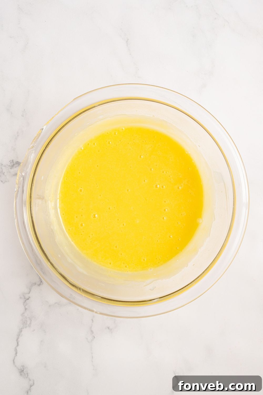 egg mixture in a glass bowl for Coconut Meringue Pie