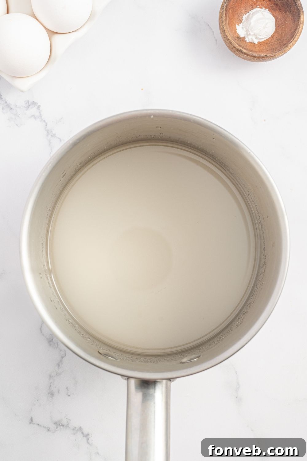 mixture for making a Coconut Meringue Pie in a saucepan