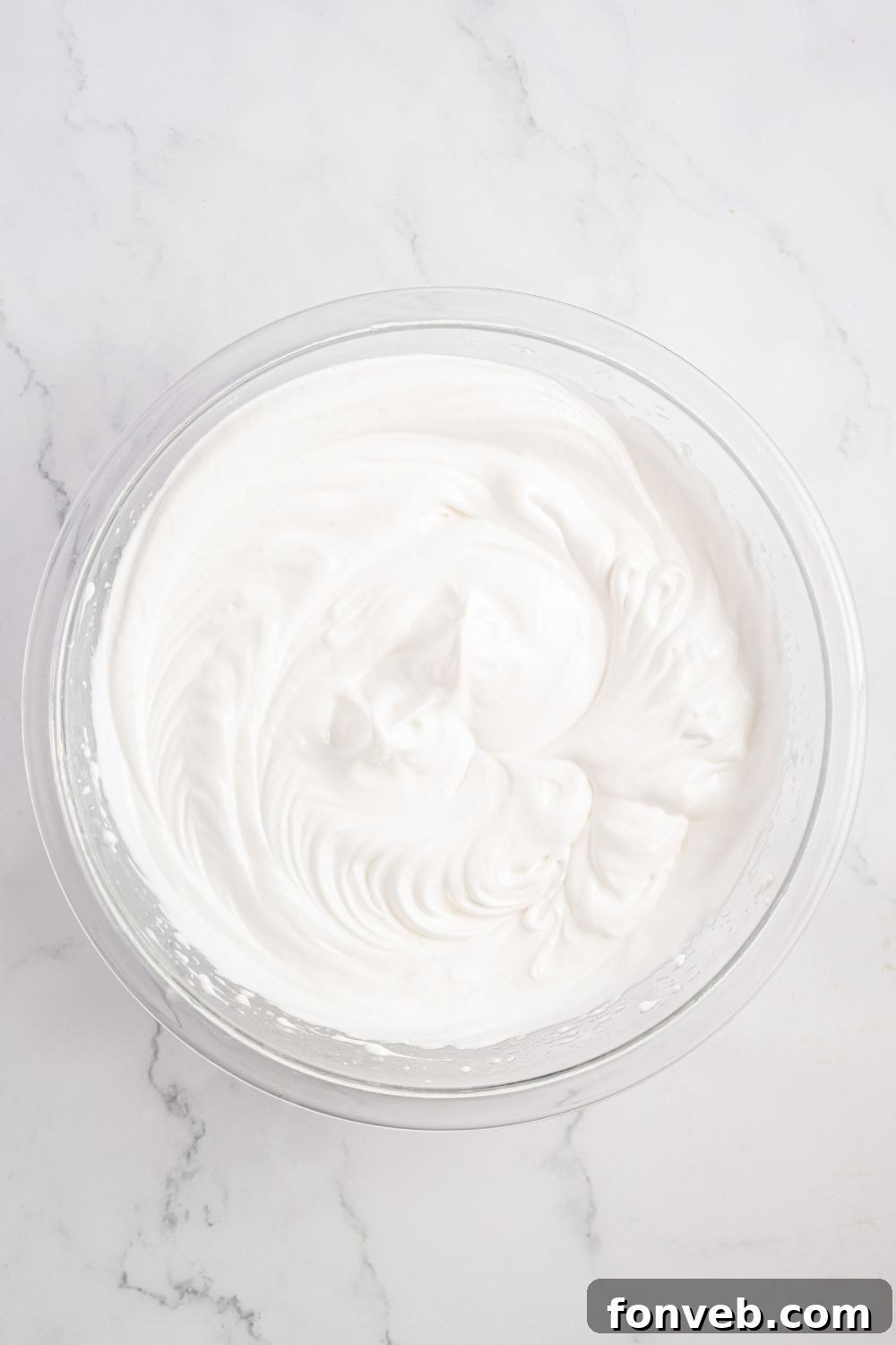 meringue in a glass bowl on table