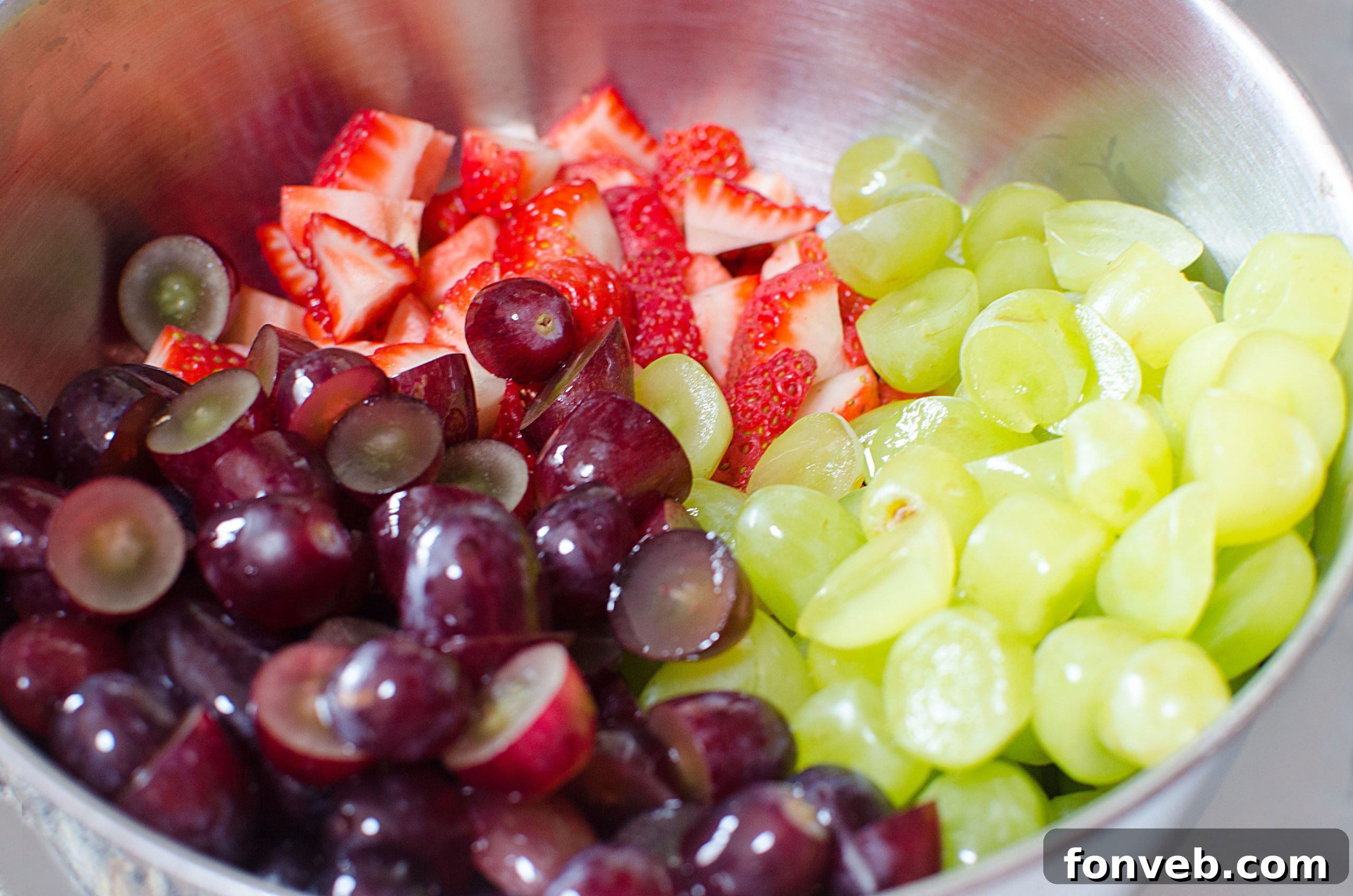 A close-up shot revealing the delightful texture and vivid colors of the fruit salad, emphasizing the fresh ingredients.