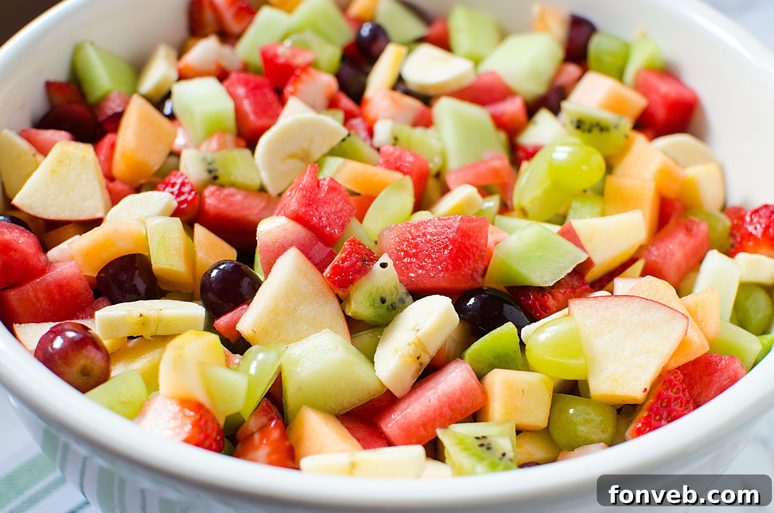 An overhead shot showcasing the abundance of fresh, colorful fruit in the salad bowl, ready to be enjoyed.