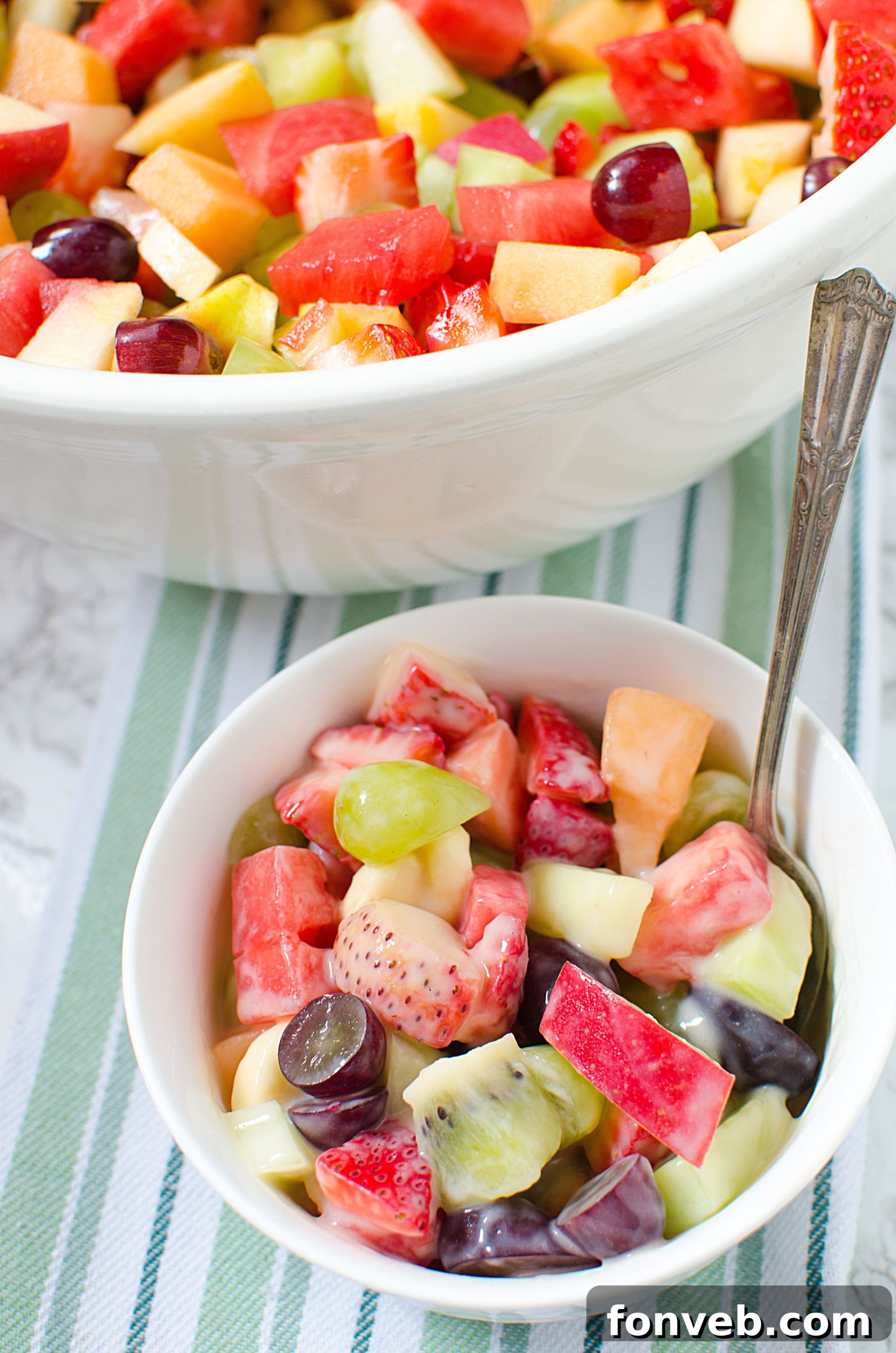 A close-up image showing a variety of chopped fruits, emphasizing the fresh quality of the ingredients chosen for the salad.