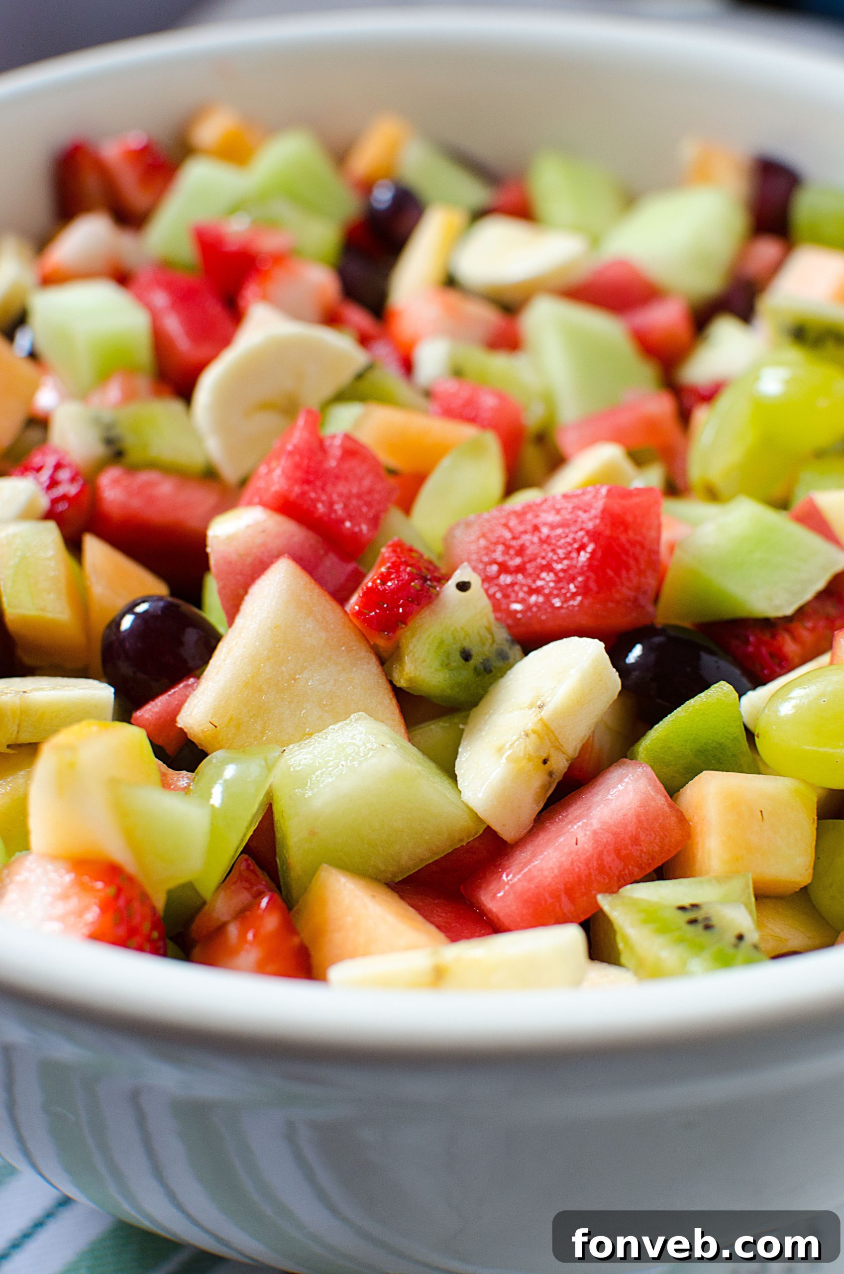 A mix of fresh, colorful fruits neatly arranged, highlighting the quality of the produce.