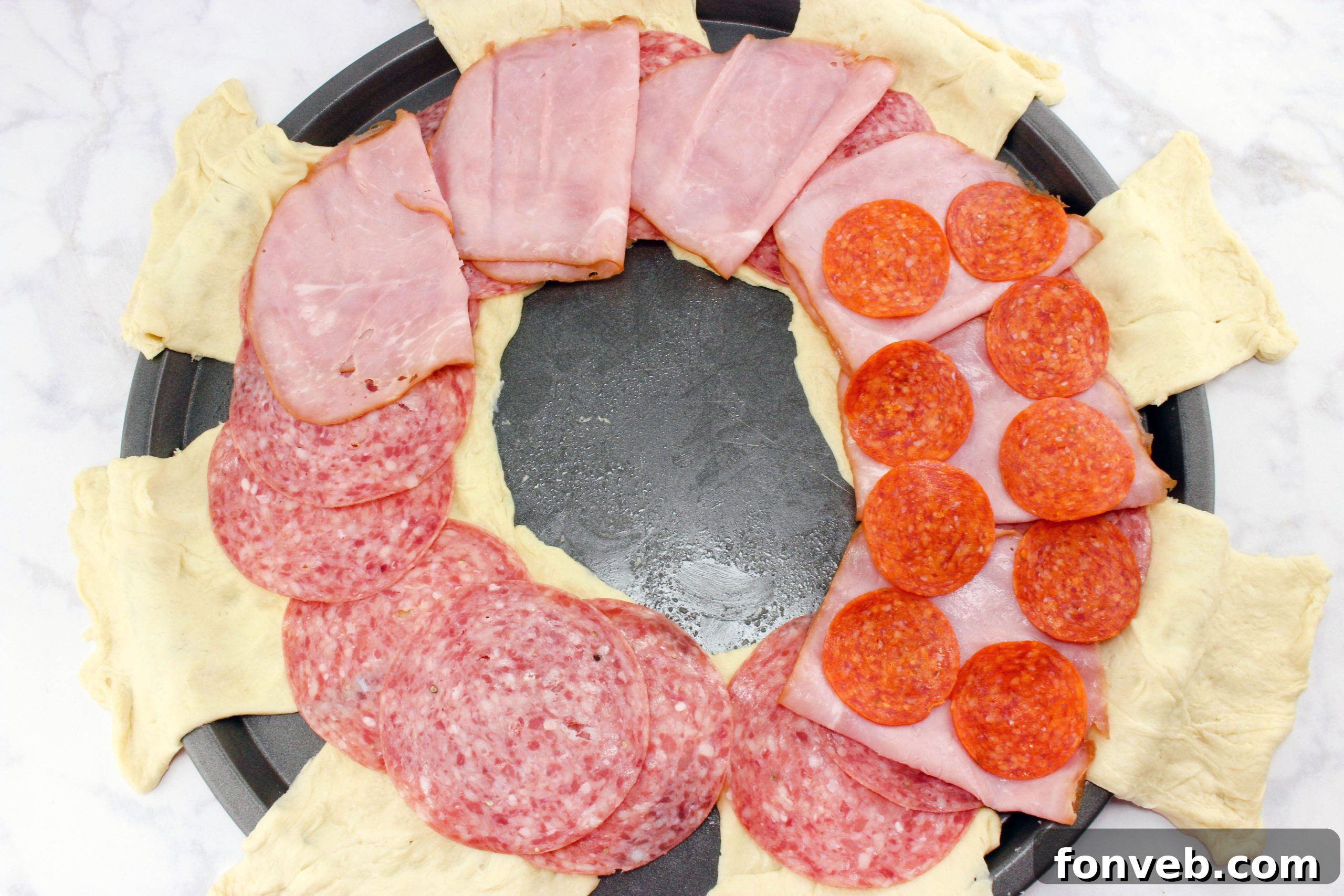 Italian Sub Crescent Bake 4 Italian deli meats and cheese laid out on crescent dough