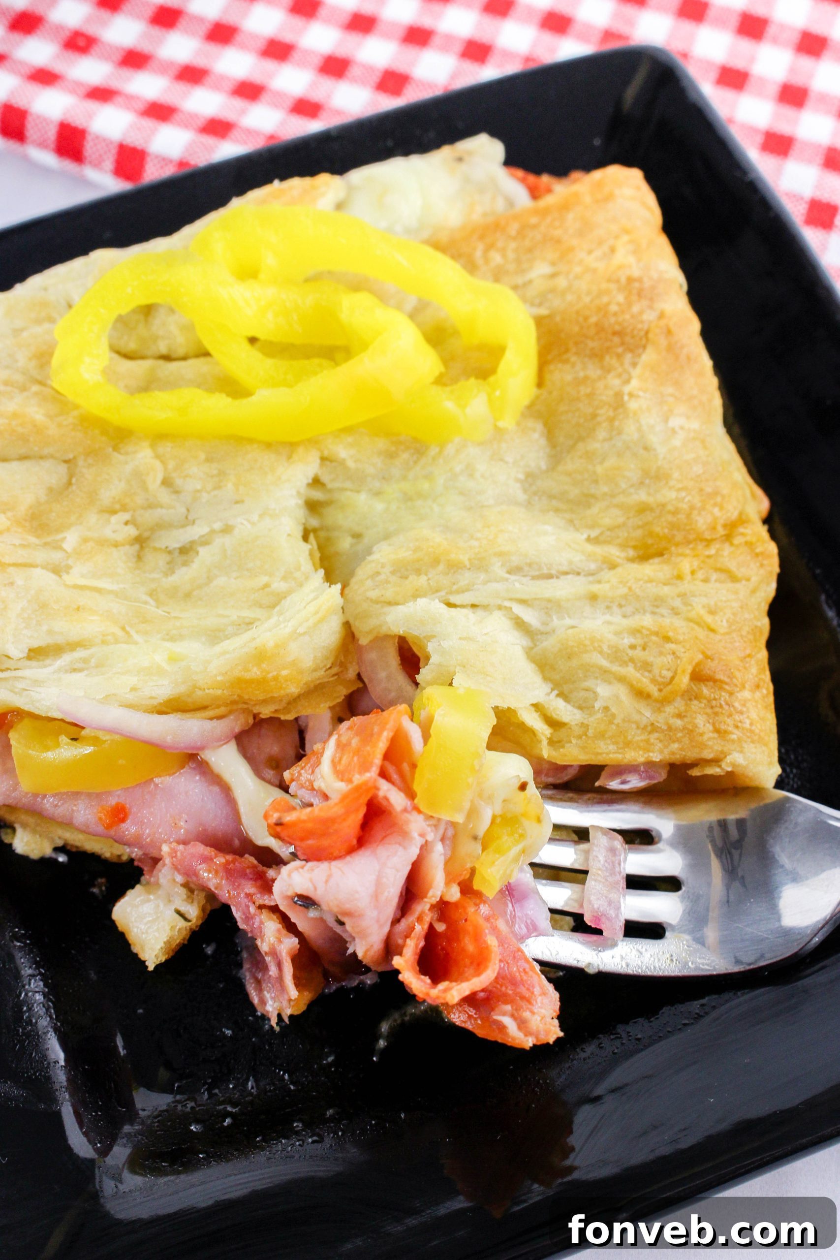 Italian Sub Crescent Bake 9 Italian oregano seasoning being sprinkled over the ingredients