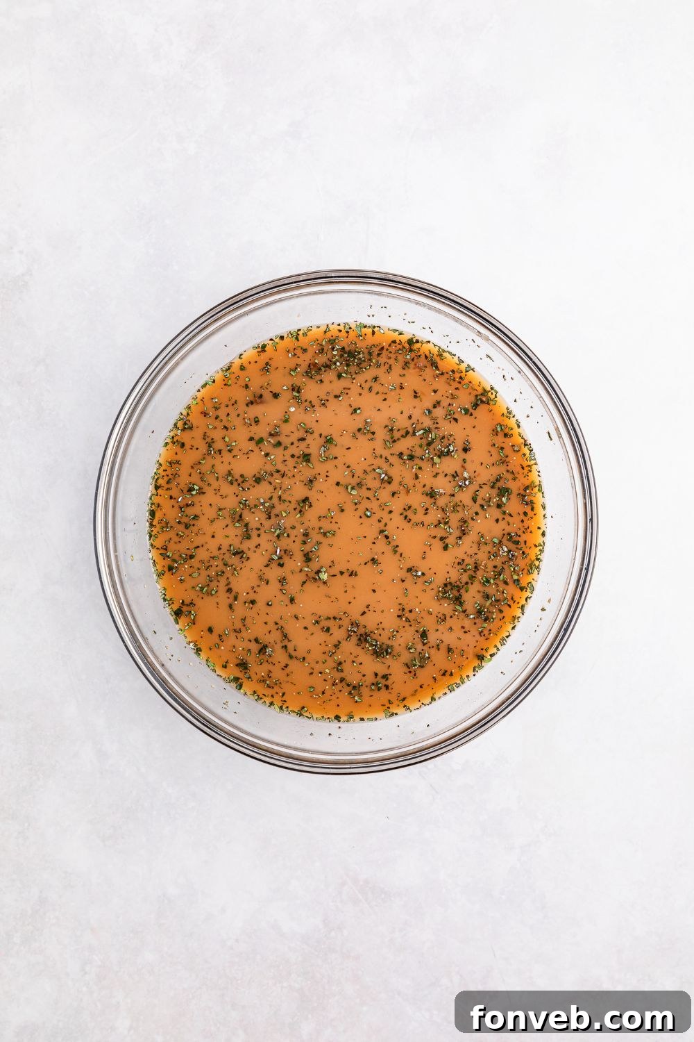 sauce in a glass bowl for making Crock Pot French Onion Meatballs
