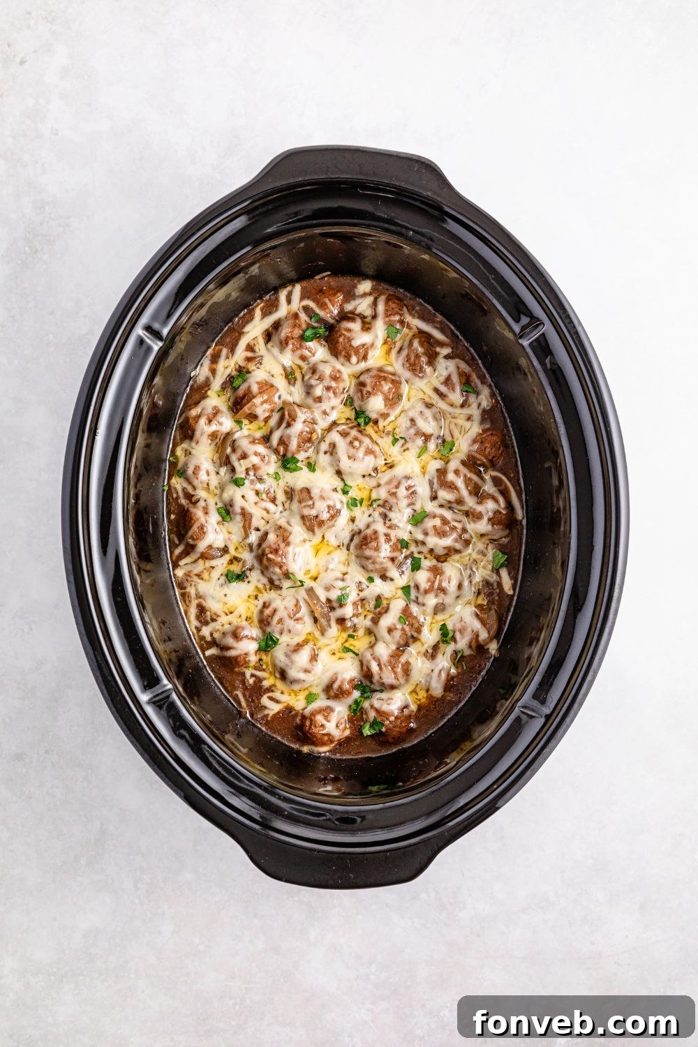 cooked Crock Pot French Onion Meatballs in a crockpot on table