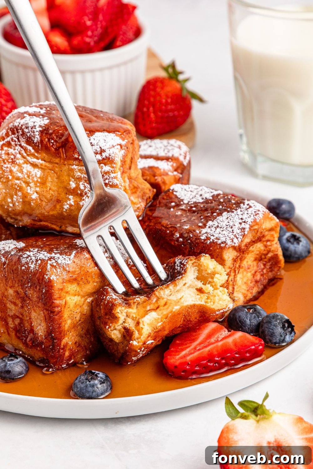 fork poking in one of the Hawaiian Roll French Toast on plate 