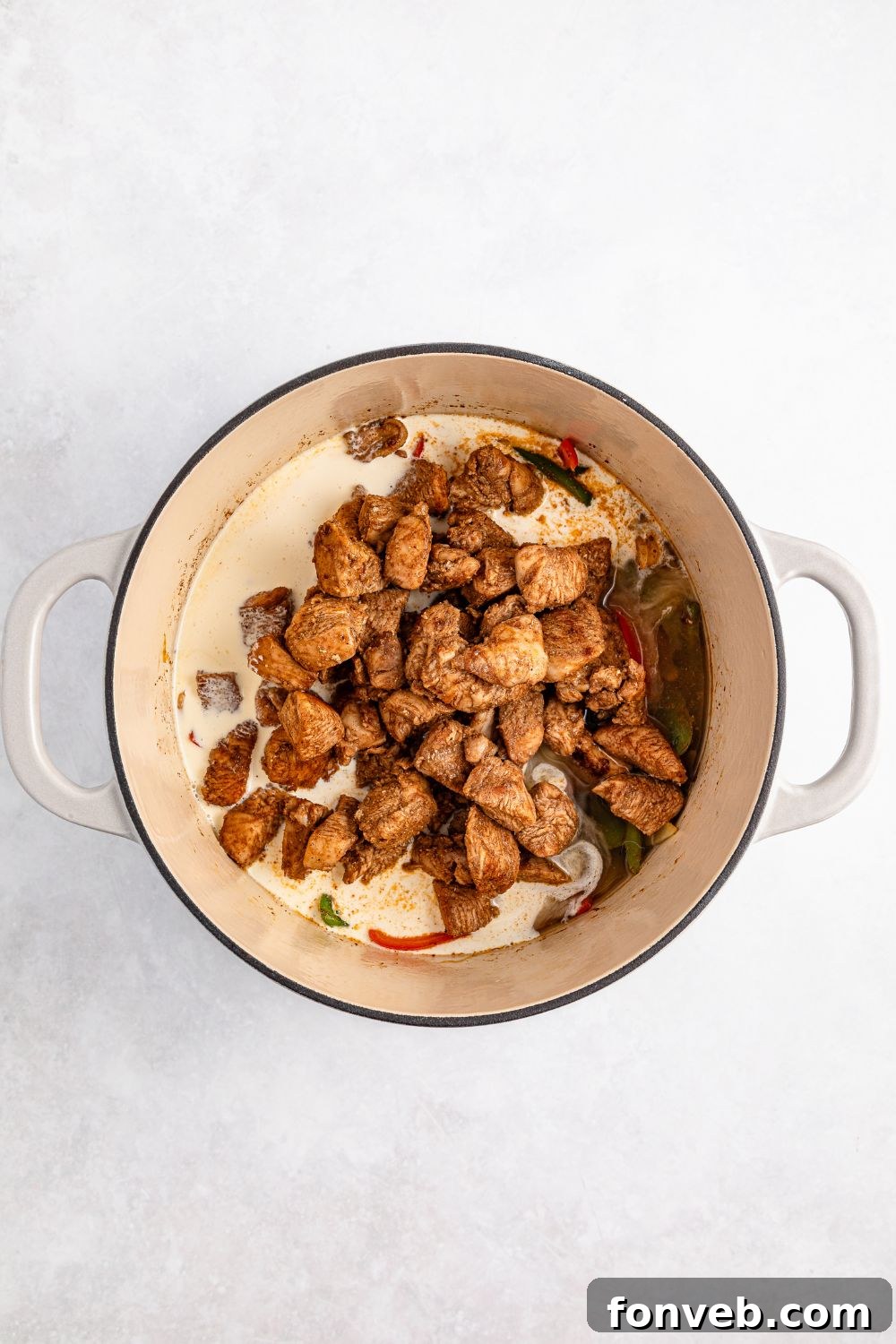 Reggae Ragu 12 seared Jamaican jerk chicken in a stockpot with heavy cream for rasta pasta