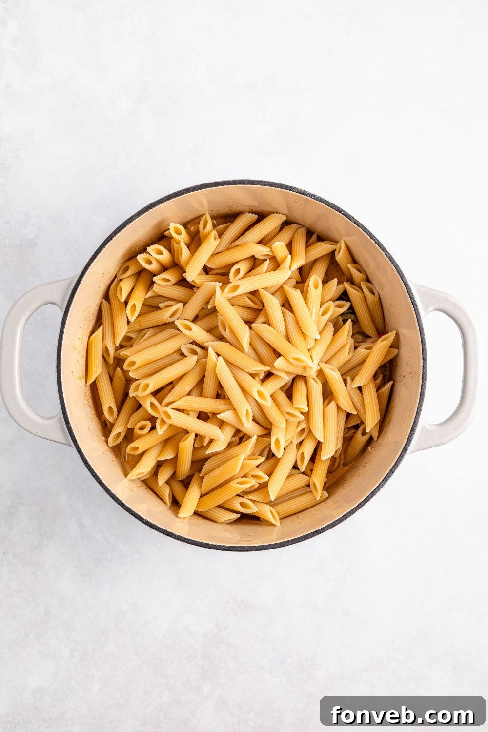 Reggae Ragu 13 uncooked pasta in a stockpot on table