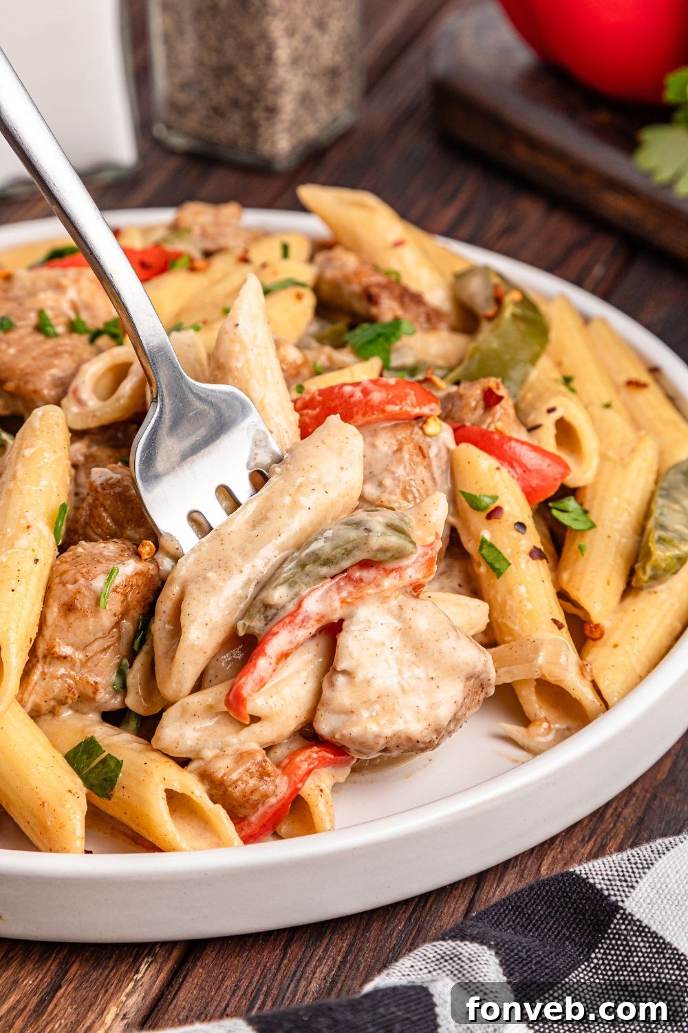 Reggae Ragu 19 fork with some chicken from the rasta pasta poked in it off the plate