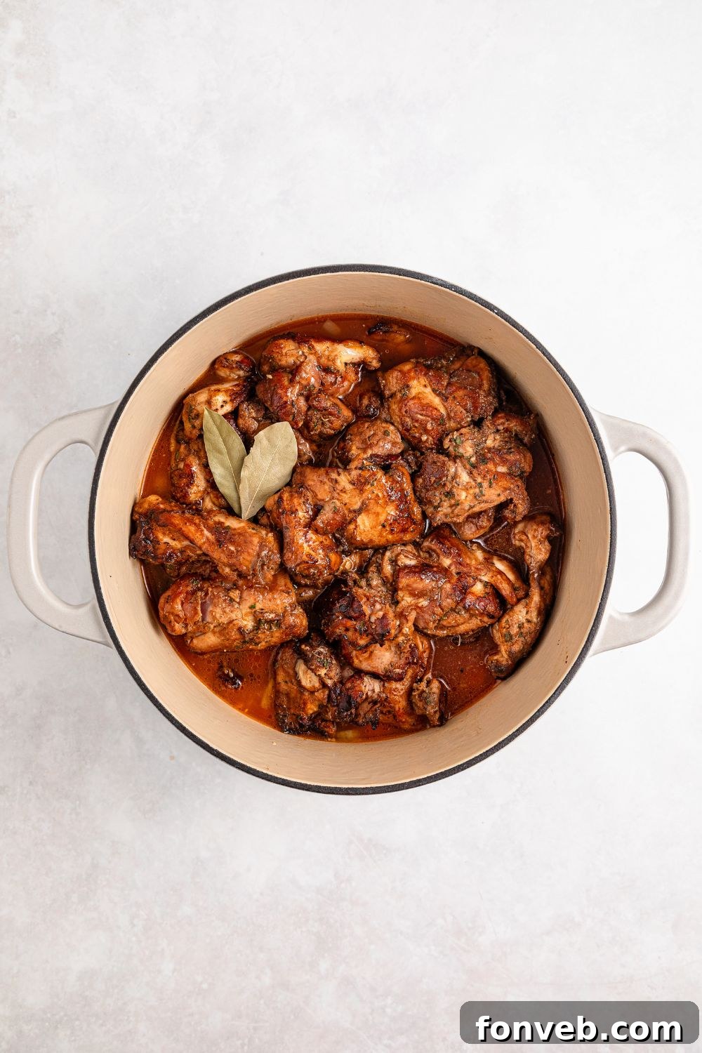 Jamaican Brown Stew Chicken in Dutch oven ready to cook on stovetop 