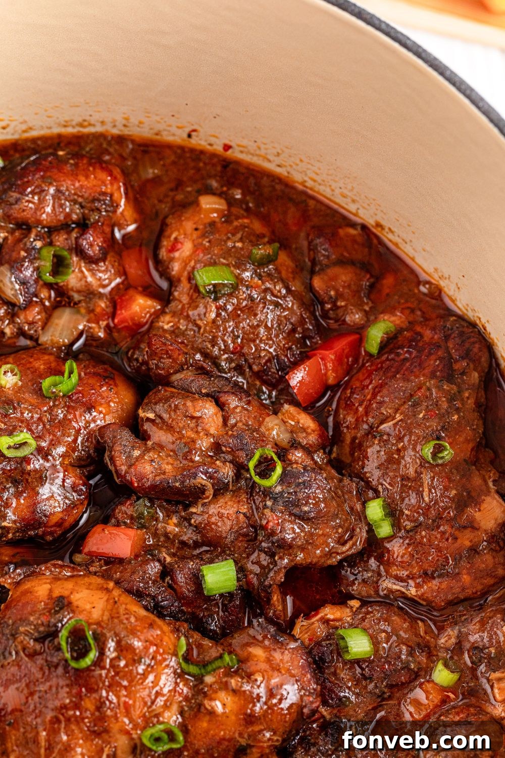 Jamaican Brown Stew Chicken in a pot close up view of meat 