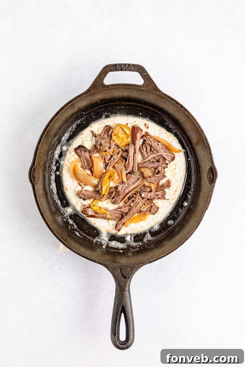 Hearty Mississippi Melt Quesadillas 12 Mississippi Pot Roast Quesadilla being assembled in pan