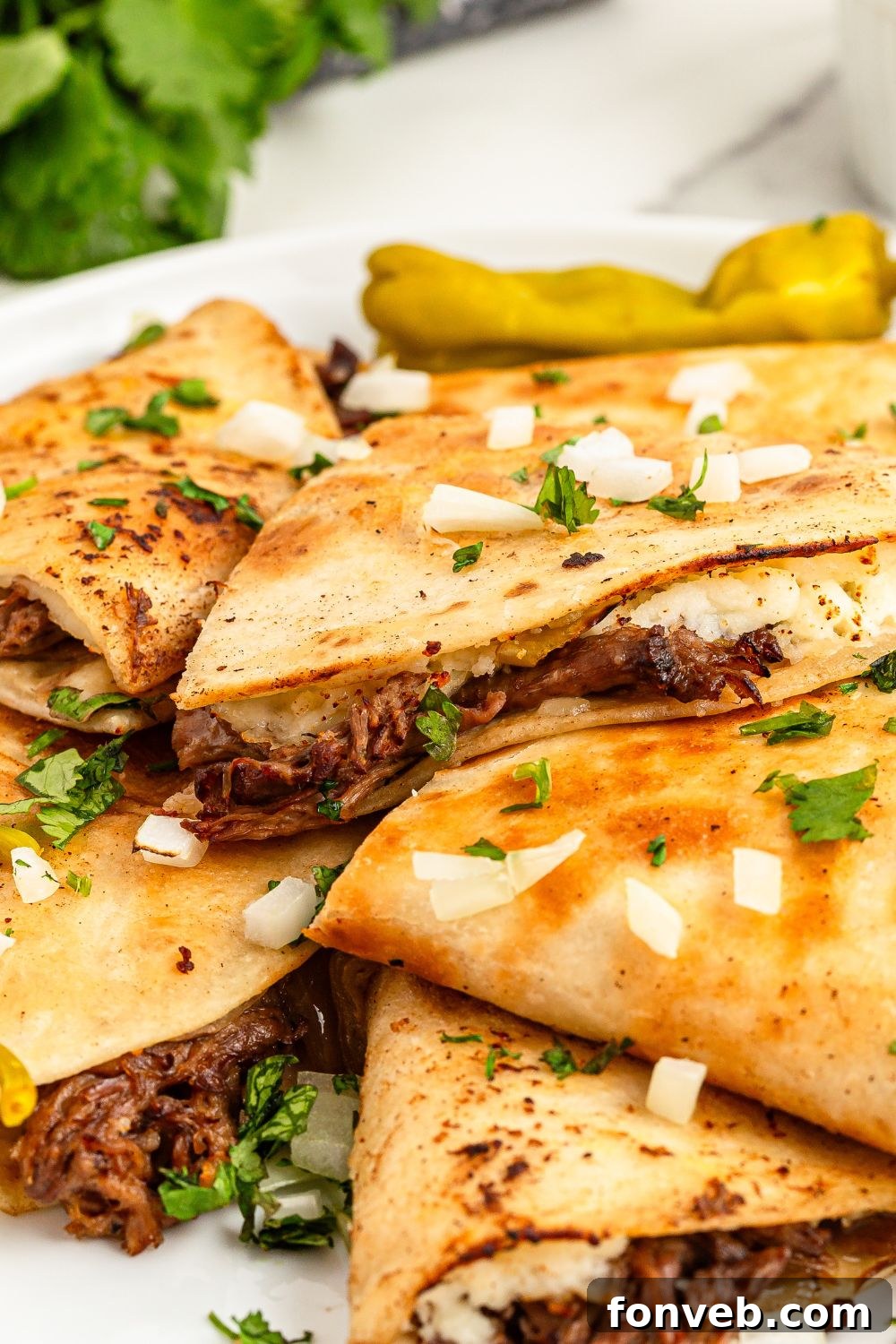 Hearty Mississippi Melt Quesadillas 17 Mississippi Pot Roast Quesadillas piled on a plate