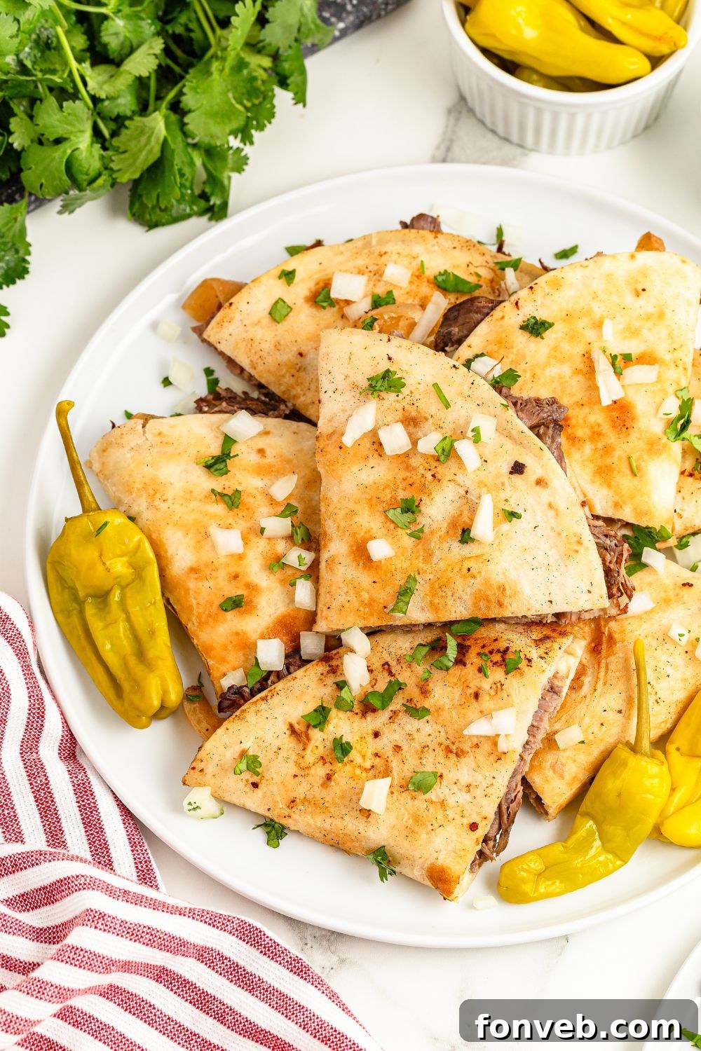Hearty Mississippi Melt Quesadillas 19 Mississippi Pot Roast Quesadillas on platter with cilantro, peppers and more all around the table