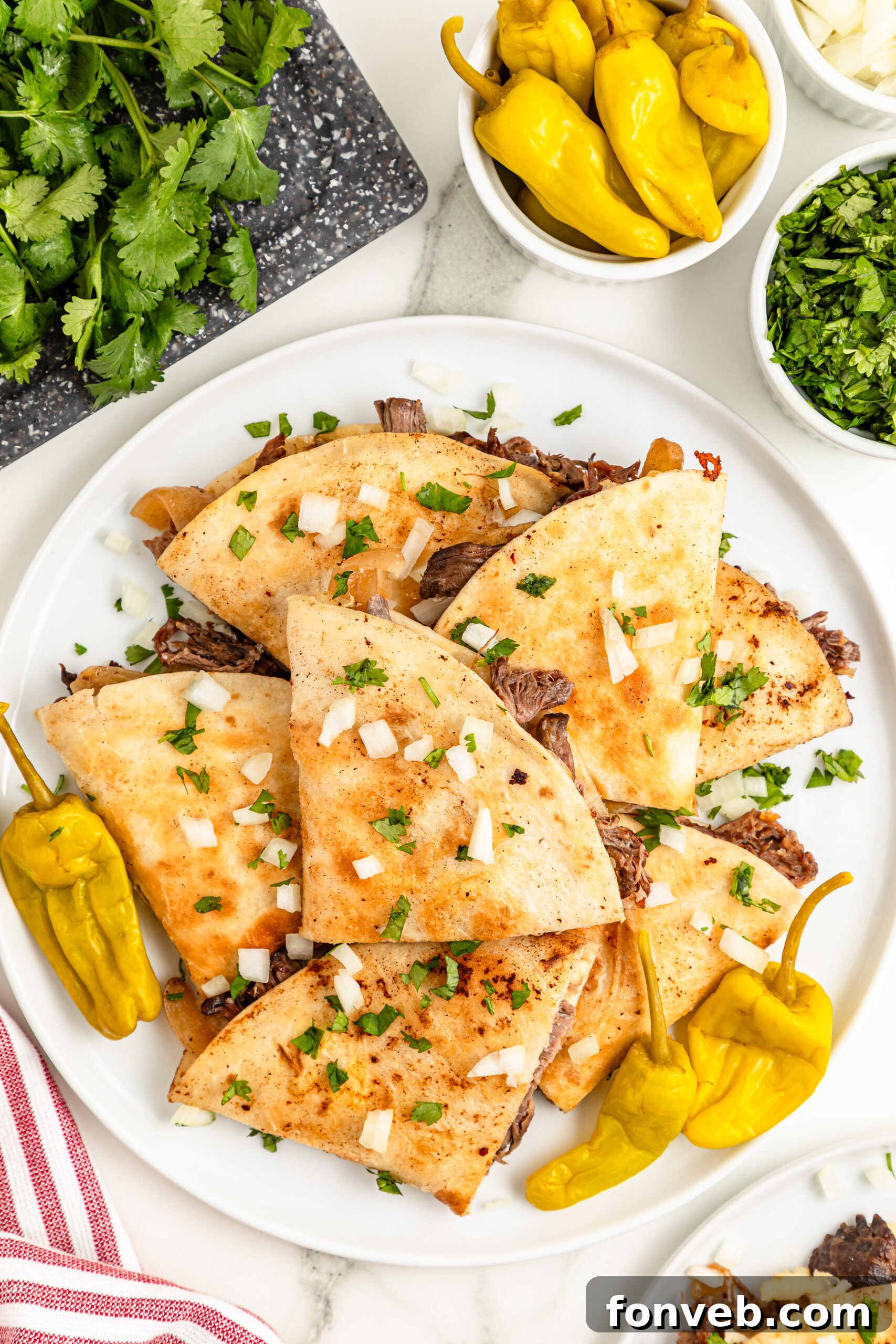 Hearty Mississippi Melt Quesadillas 3 overhead shot of the Mississippi Pot Roast Quesadillas piled on a white plate