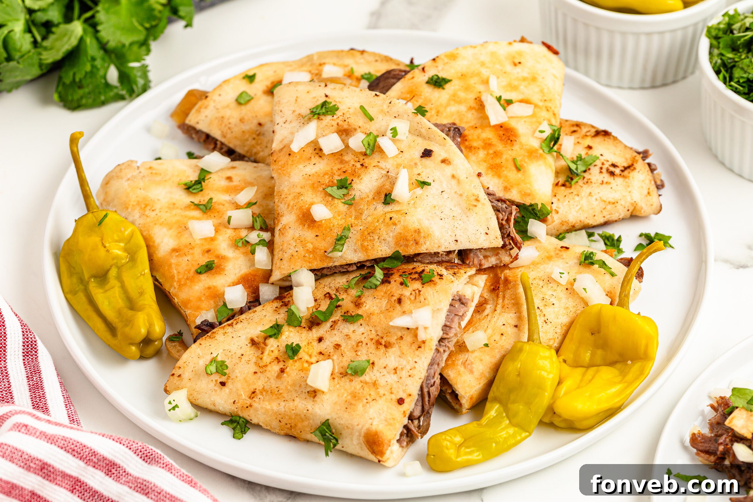 Hearty Mississippi Melt Quesadillas 5 Mississippi Pot Roast Quesadillas piled on a plate topped with onions