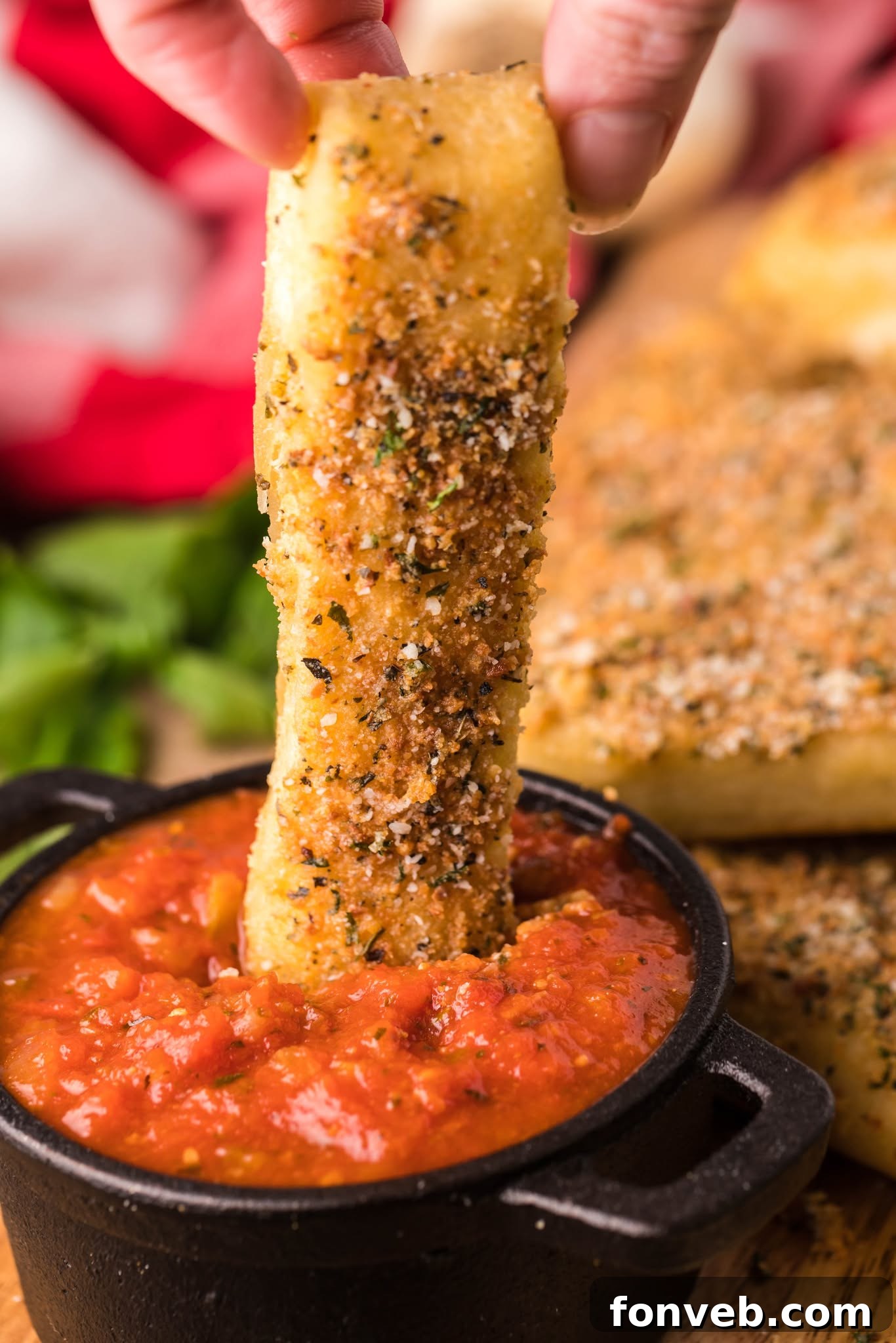 Homemade Pizza Hut Breadsticks 7 Copycat Pizza Hut Breadstick being dipped into a cup of marinara sauce