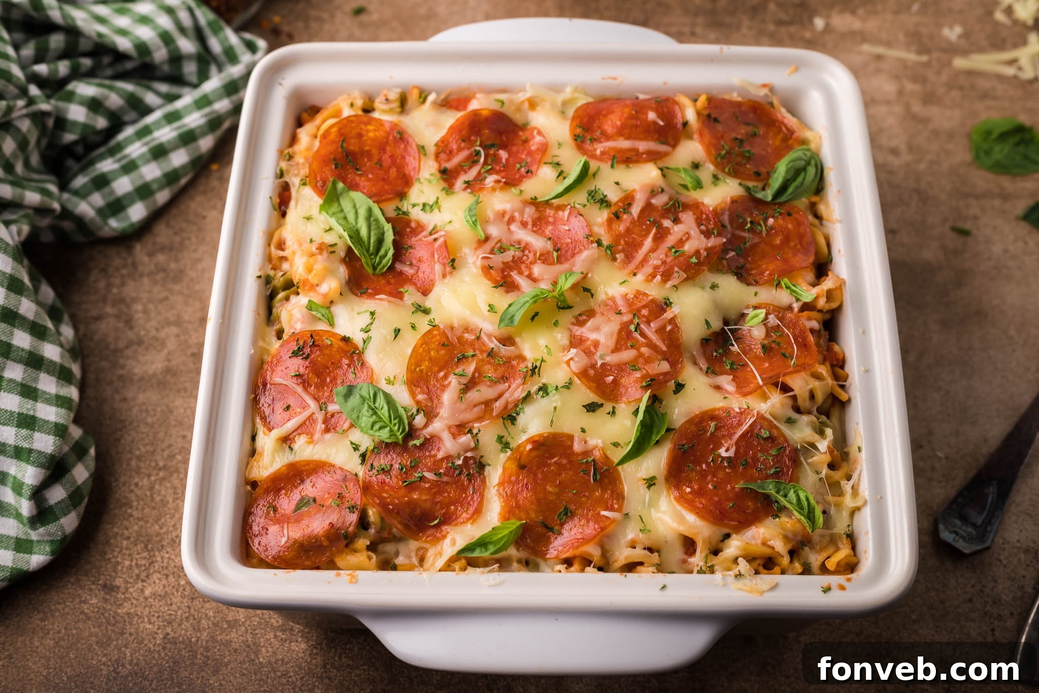Cheesy TikTok Pizza Pasta Bake 4 Tik Tok Pizza Pasta Casserole in a square white baking dish
