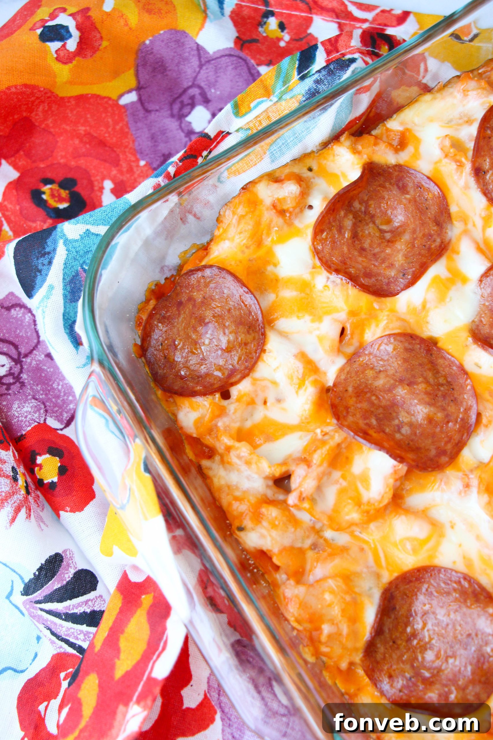 Pasta sauce and softened cream cheese being combined for the creamy base of the pasta bake