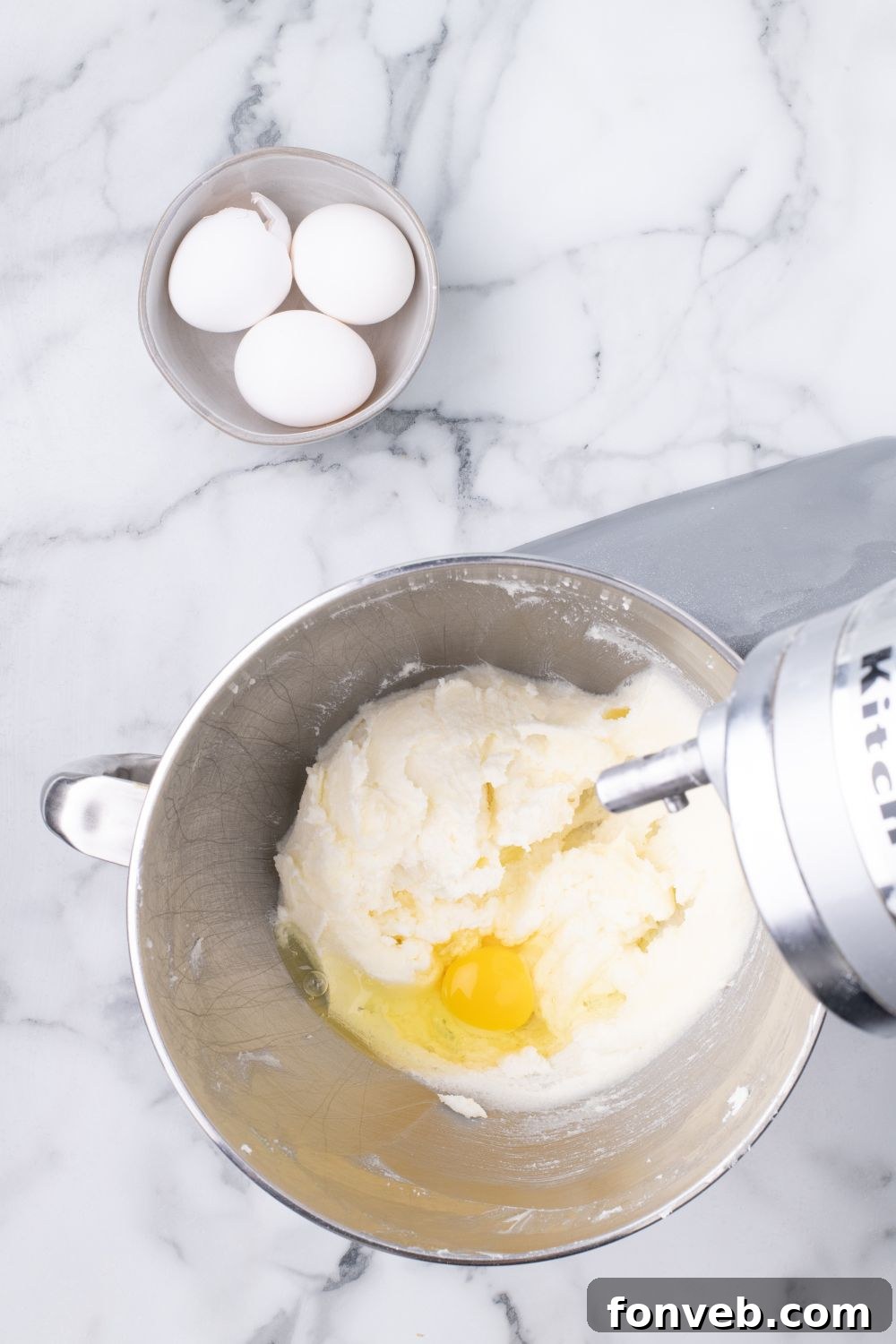 Decadent Chocolate Cream Dream 14 A stand mixer actively beating eggs and cake batter, demonstrating a key step in the baking process.