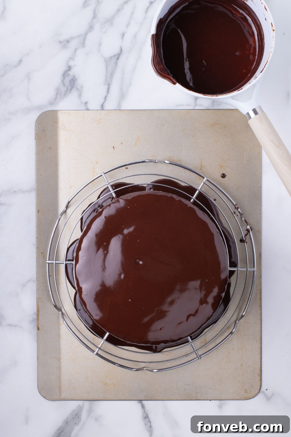 Decadent Chocolate Cream Dream 18 A beautifully glazed Ding Dong Cake resting on a tray, with rich chocolate ganache gracefully dripping down its sides, highlighting its decadent finish.