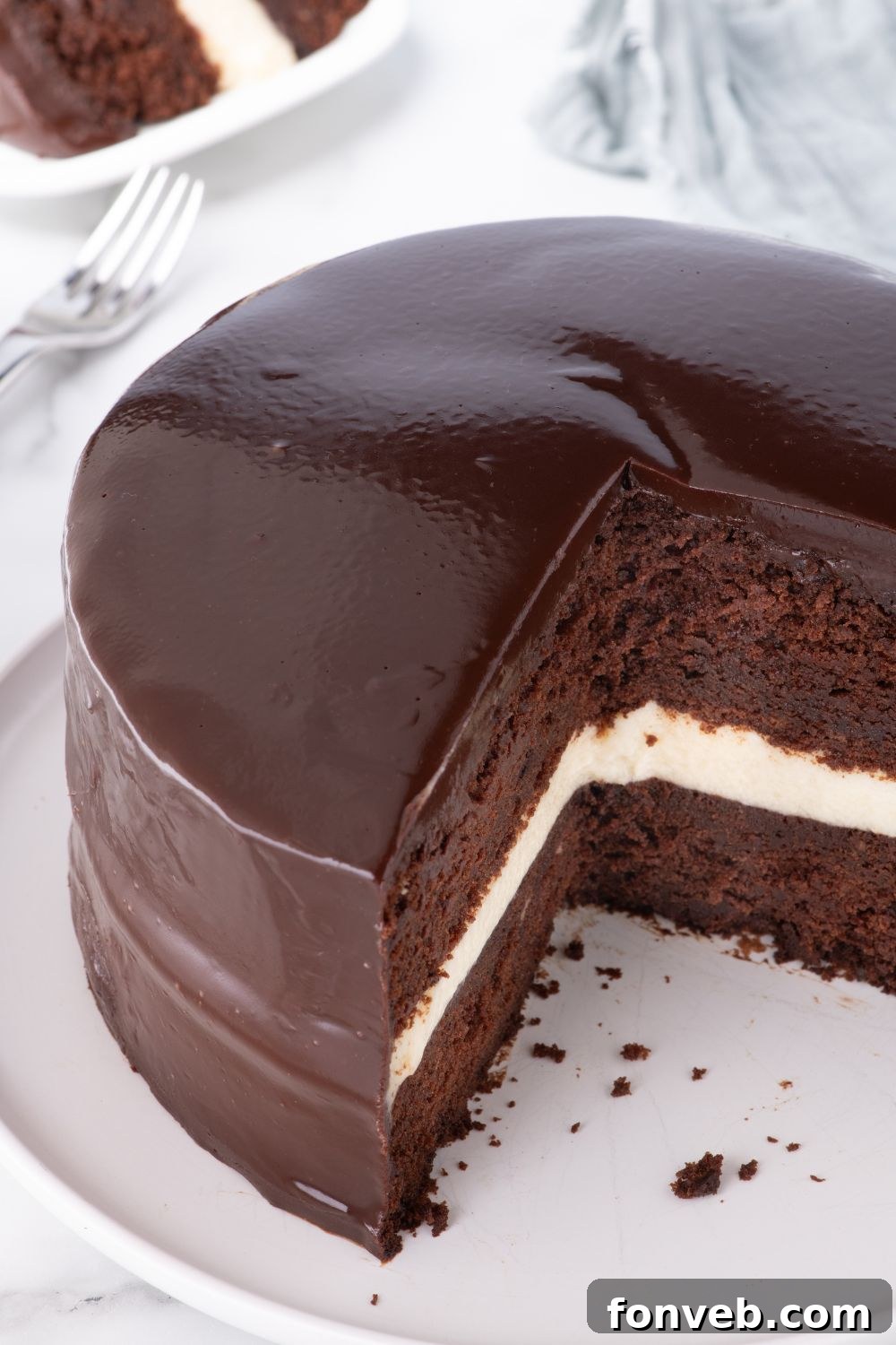 Decadent Chocolate Cream Dream 21 An overhead perspective of a Ding Dong Cake on a table, with a few tempting slices already taken out, revealing its inviting interior.