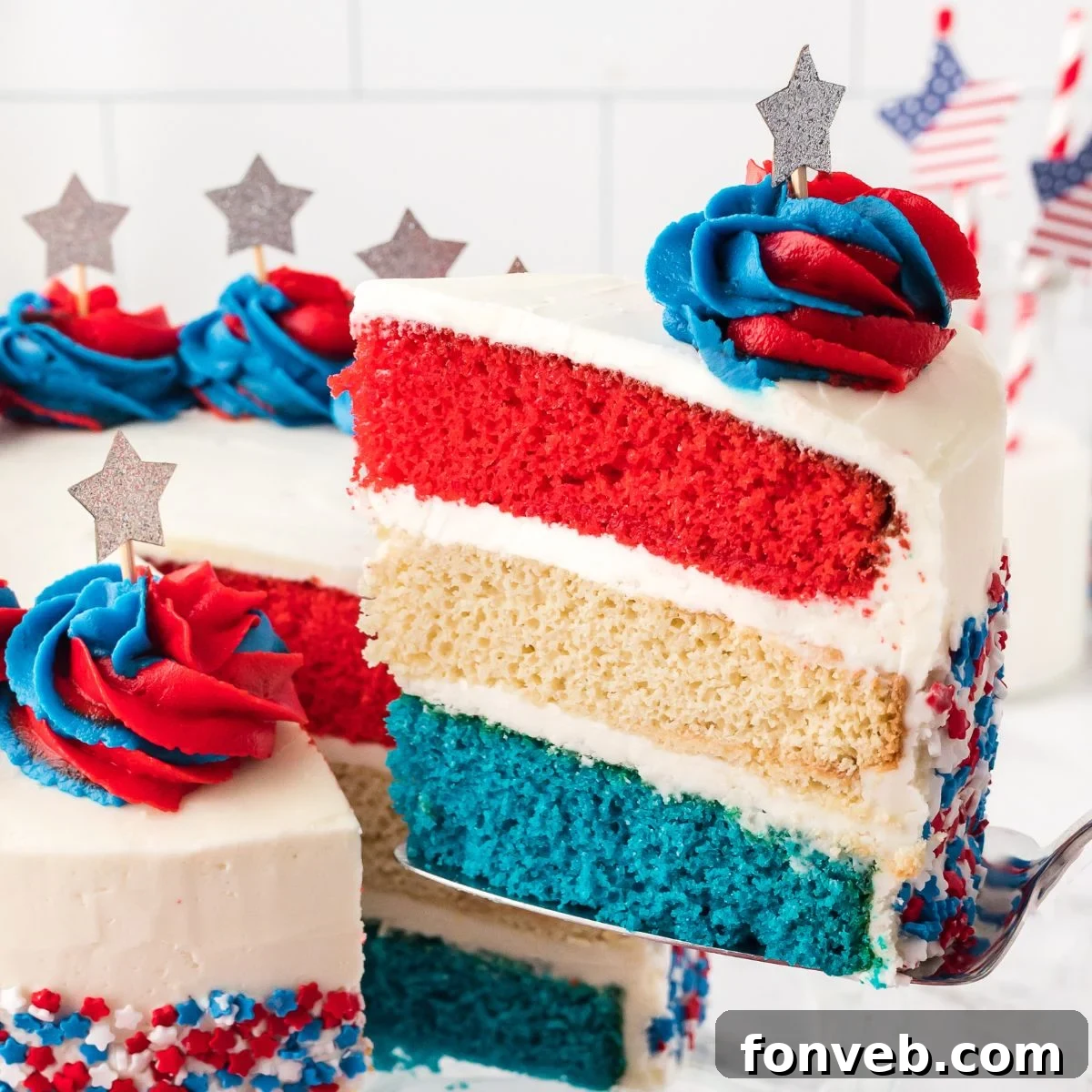 American Flag Cake with a slice being lifted out with spatula 