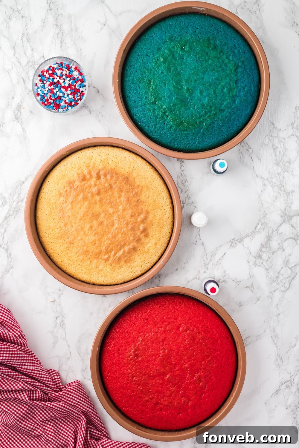 round cakes that are red, white, and blue sitting on table in pans 