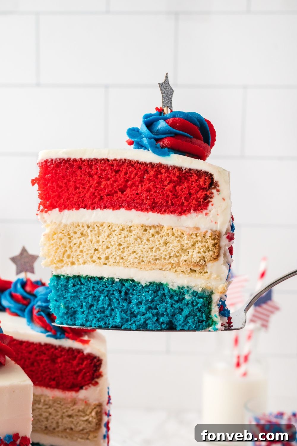 American Flag Cake with a slice taken out of it being lifted out of container