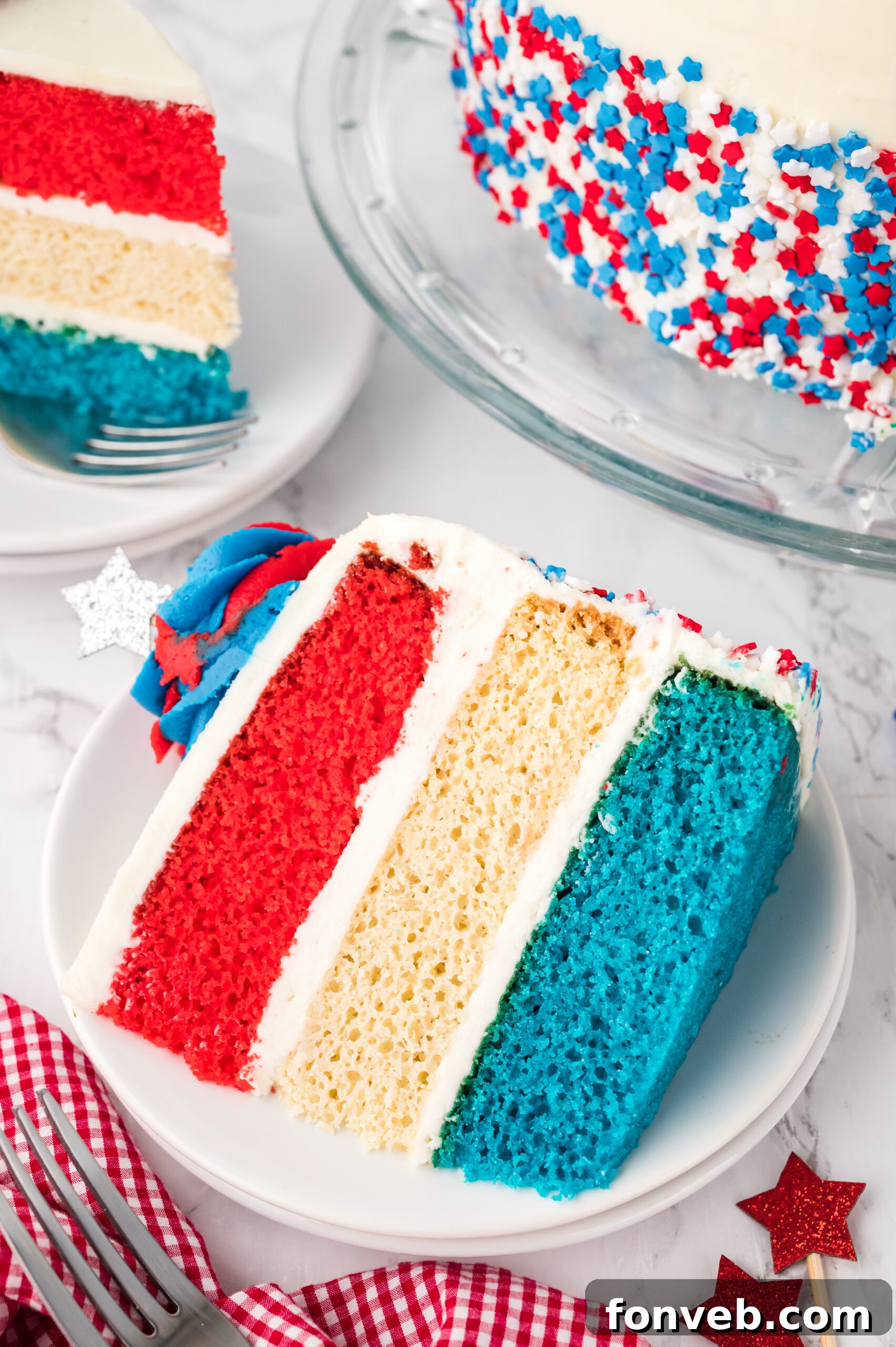 overhead shot of a Slice of American Flag Layered Cake on a white plate 