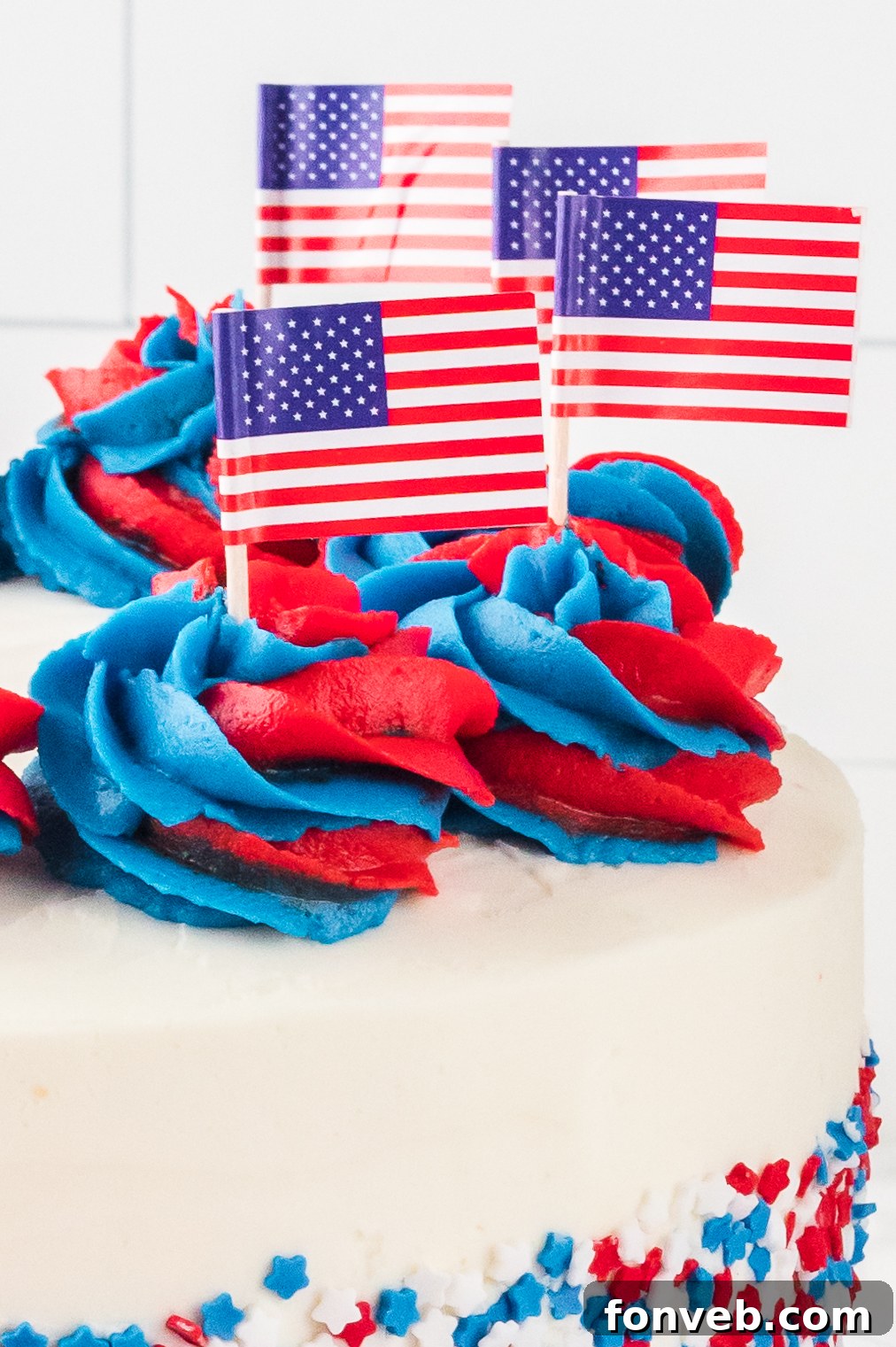 close up of the frosting topped with tiny american flags on top of the whole uncut American Flag Layered Cake 