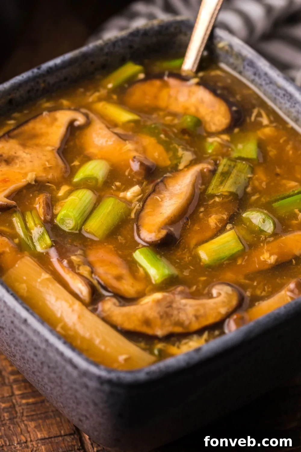 PF Chang's Fiery & Tangy Soup 5 PF Changs Hot And Sour Soup in a square bowl with a spoon in bowl