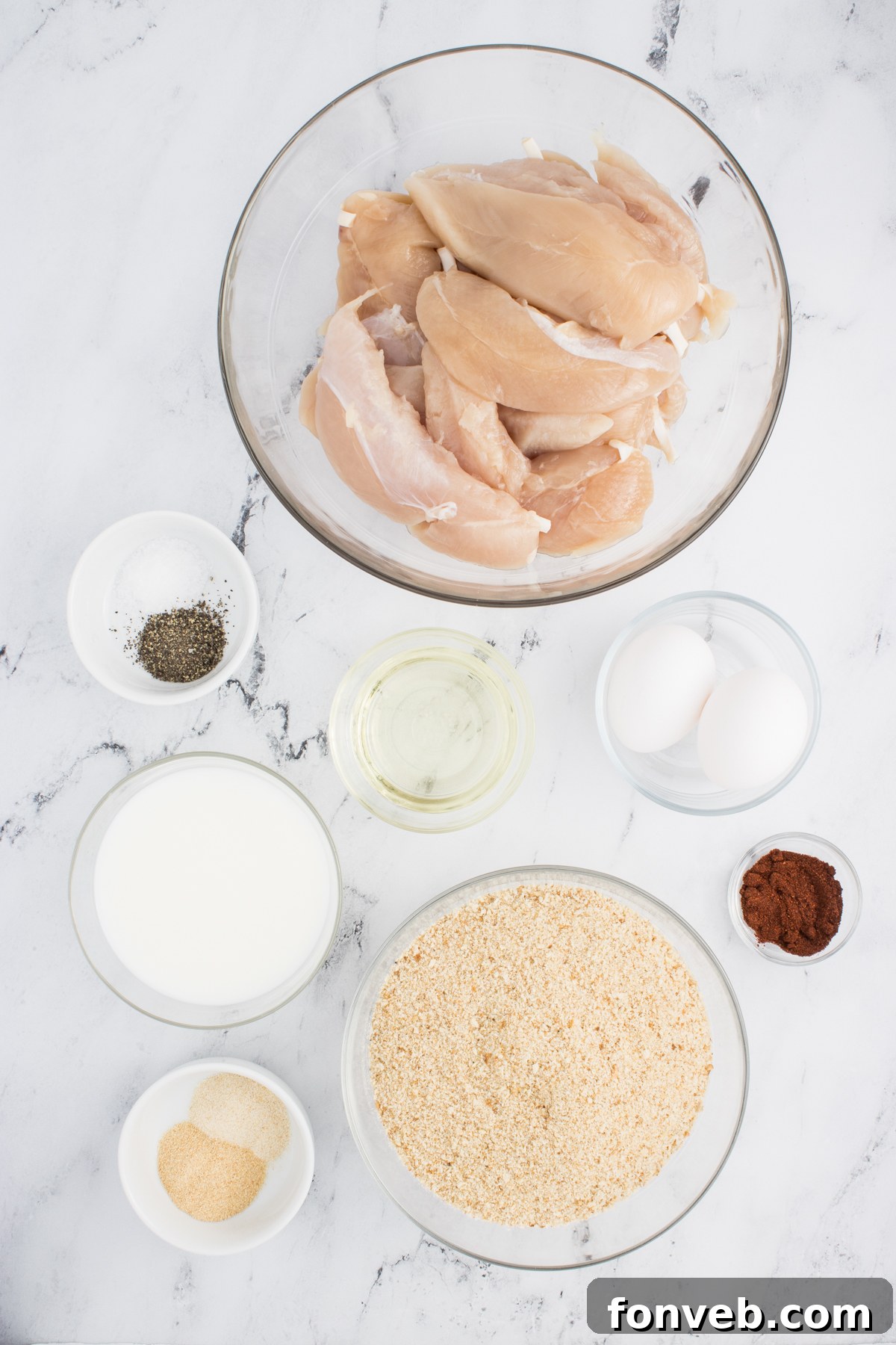 Ultra Crispy Air Fryer Chicken Tenders 5 All the fresh and dry ingredients for making Air Fryer Chicken Tenders laid out neatly on a clean kitchen counter