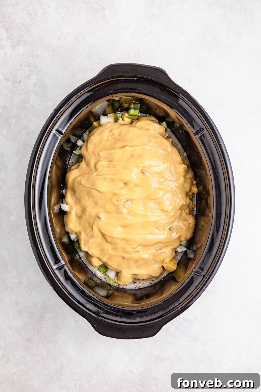 Easy Slow Cooker Chicken Pot Pie 11 cream of chicken soup poured over veggies in slow cooker on table