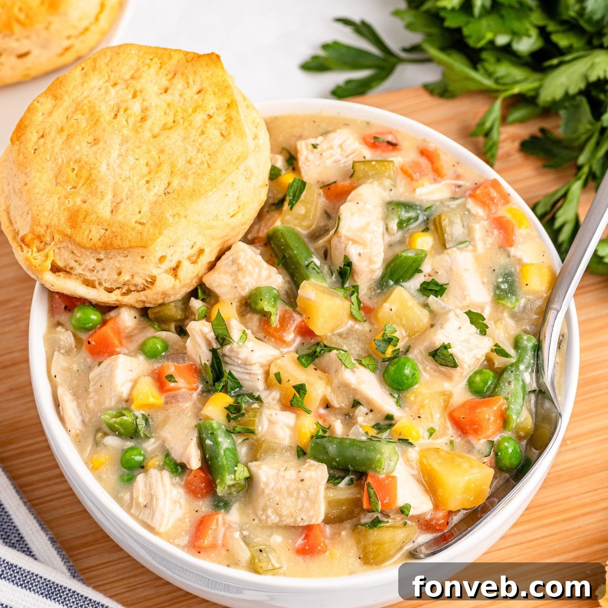 Easy Slow Cooker Chicken Pot Pie 5 Slow Cooker Chicken Pot Pie in a bowl with a biscuit on side of bowl